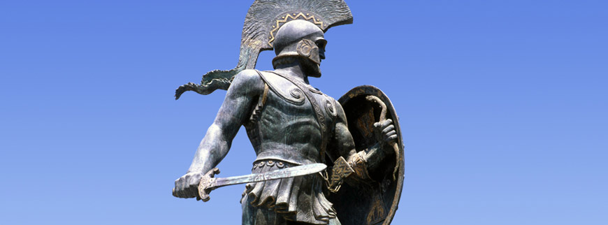 A statue of a Spartan warrior holding a shield, embodying the Spartan Way.