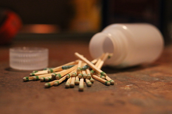 Matchsticks scattered out from a plastic bottle.