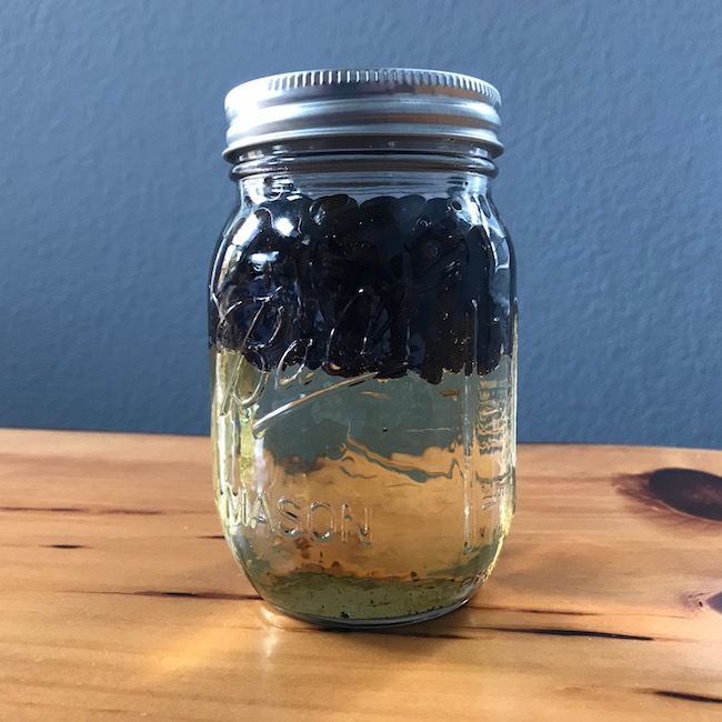 Coffee martini, both black and white in a jar.