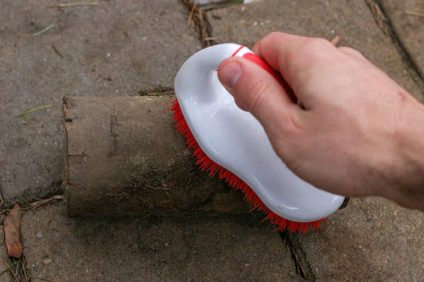 Cleaning log with stiff brush.