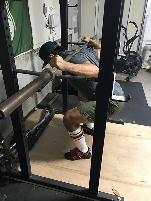 A man with Pin Squats.