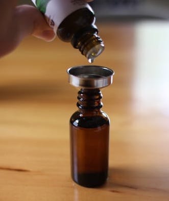 Shifting beard oil in to another bottle.
