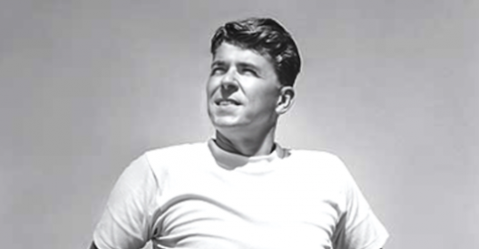 A black and white photo of a man in a white shirt, possibly from the Reagan era.