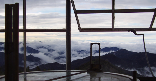 A cloudy sky over a mountain, offering solitude.