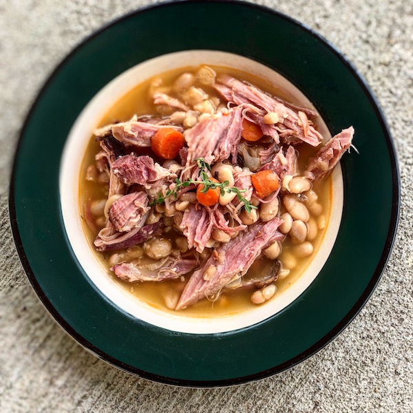 Ham and white beans dish in a plate.