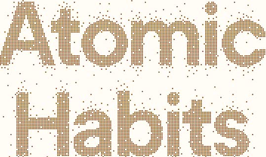The word atomic habits in gold dots on a white background.