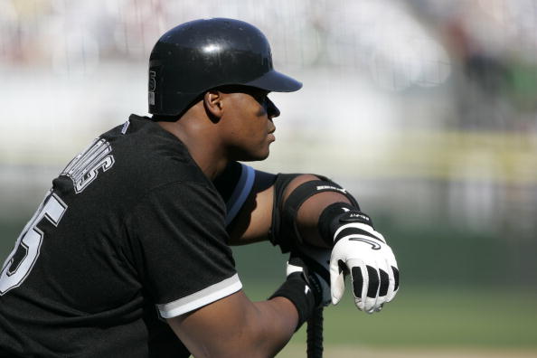 Don't Believe the Hype - A baseball player leans on a baseball bat.