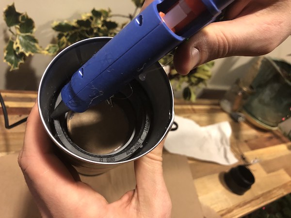 Gluing the PVC to fit in a can.
