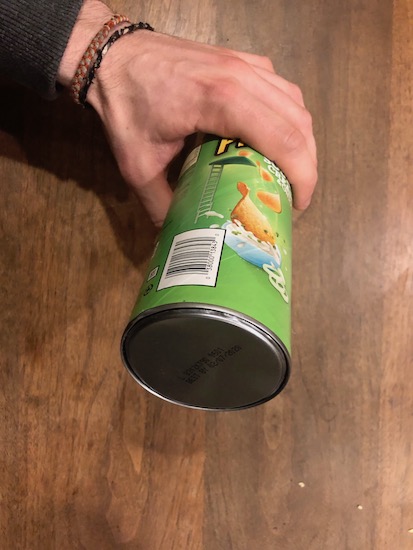 Man holding safe made with Pringles can.