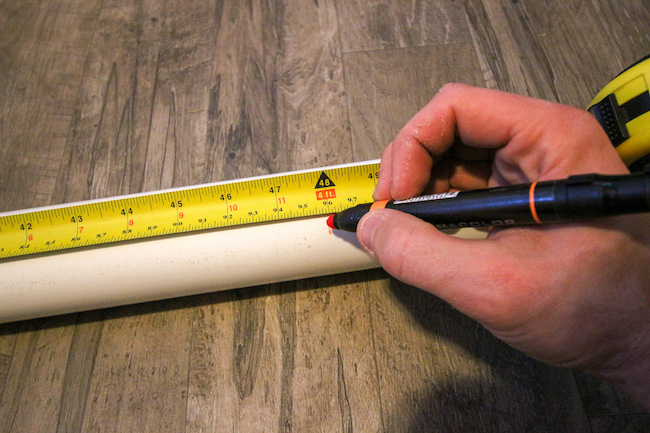 Measuring pipe with scale and pen.