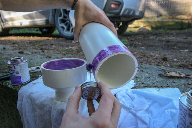 Applying glue adapter onto one end of pipe.