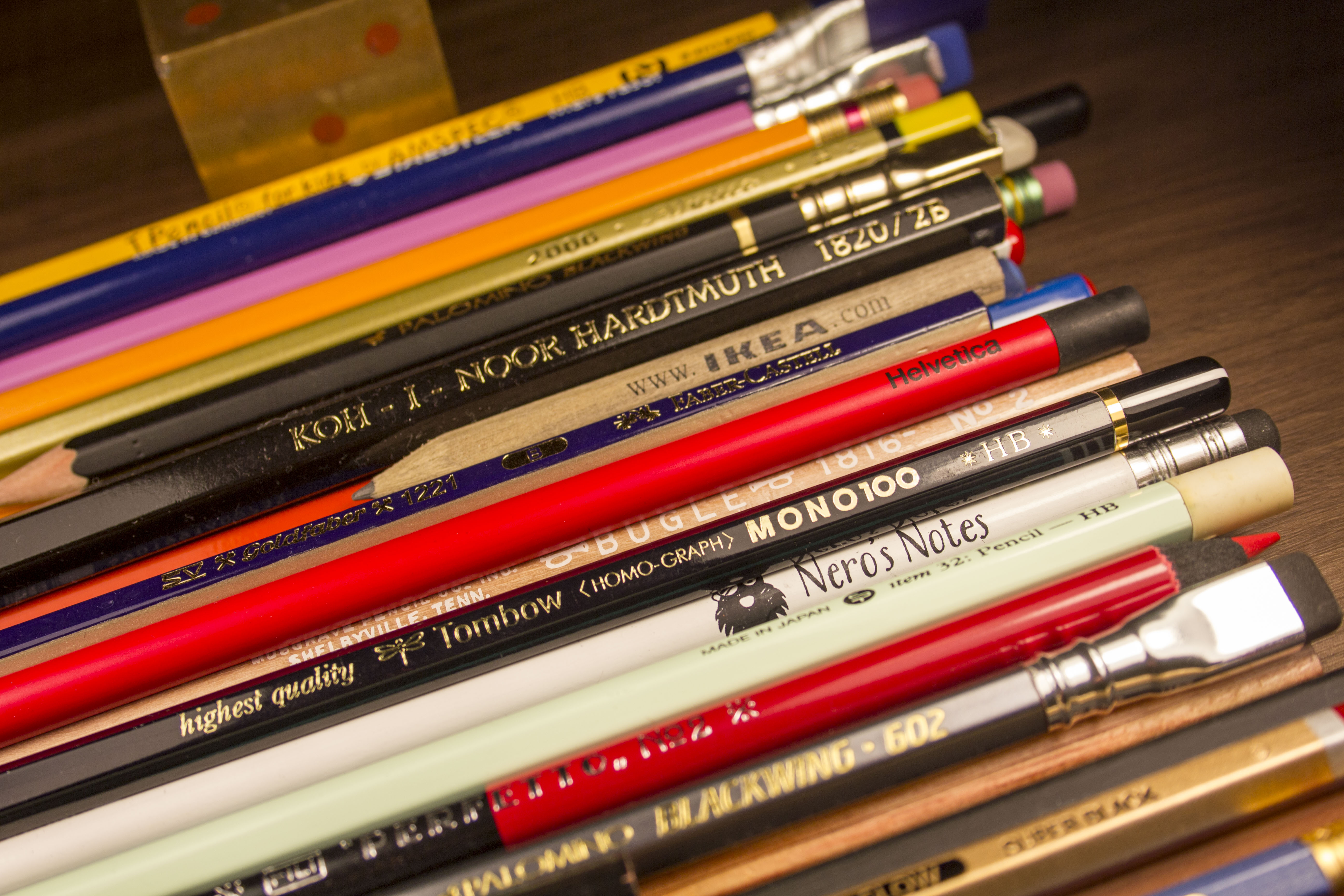 A group of colored pencils on a table.