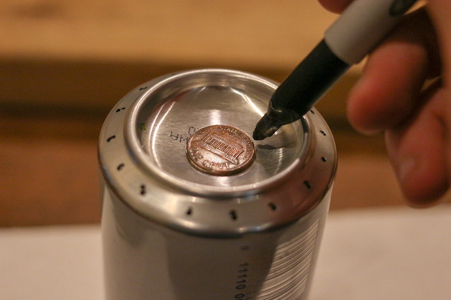 Marking penny on can.