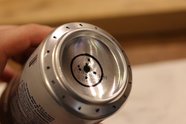 Holes and marks displayed at the bottom of can.