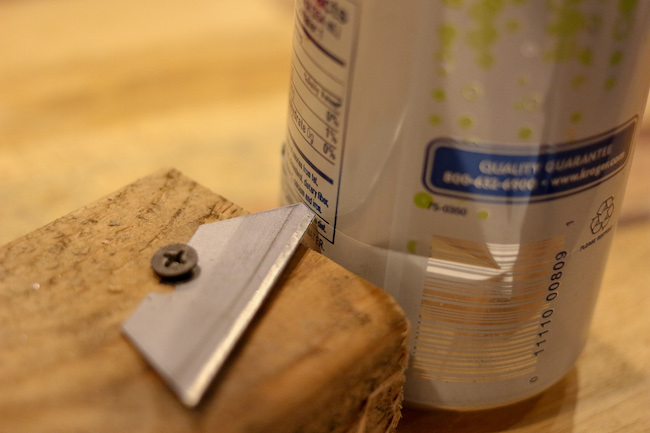 Cut base of can along with wooden box and a nail drilled in it.