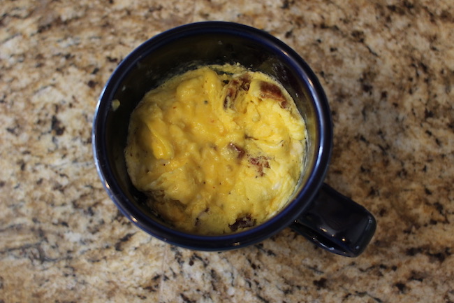 Microwaved the paste of eggs, cheese and sausage in cup.
