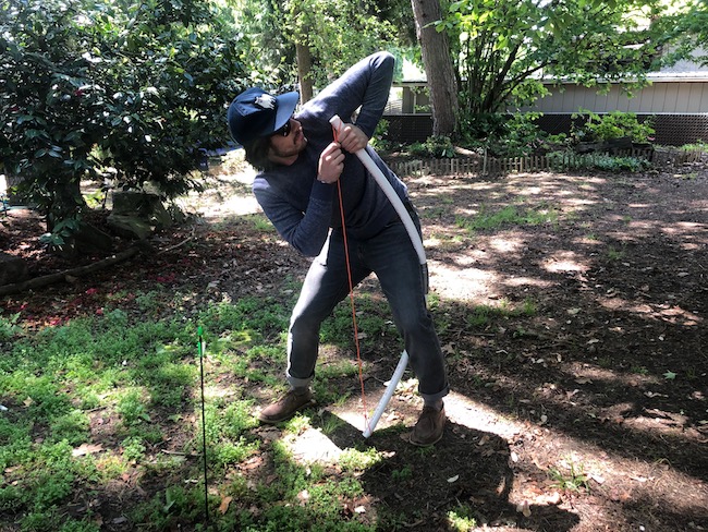 Man stringing the bow by hands.