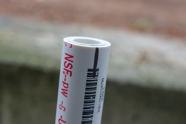 PVC pipe with marker indication displayed on it. 