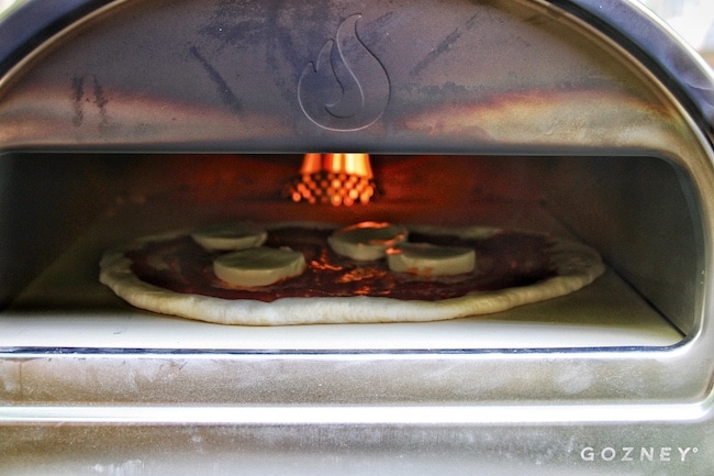 Pizza getting cooked in Roccbox oven.