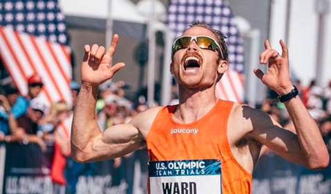 An Olympic marathoner is celebrating his victory in the race.
