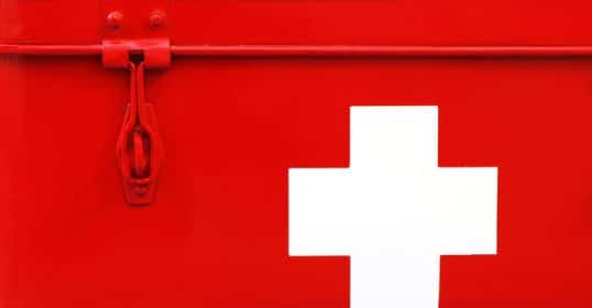 A red first aid box with a white cross on it, perfect for your DIY first aid kit.