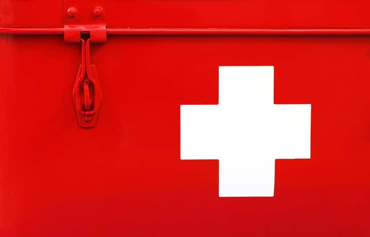 A red first aid box with a white cross on it, perfect for your DIY first aid kit.