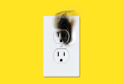 A white outlet with a fire on it on a yellow background, showcasing the potential catastrophes that can arise.