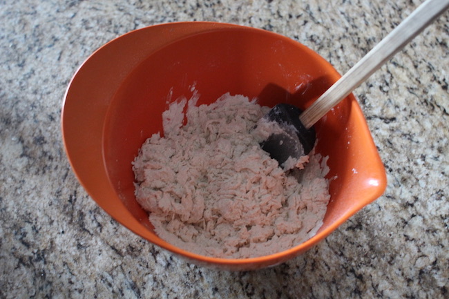 Step 2: Begin adding water in small amounts. Knead.