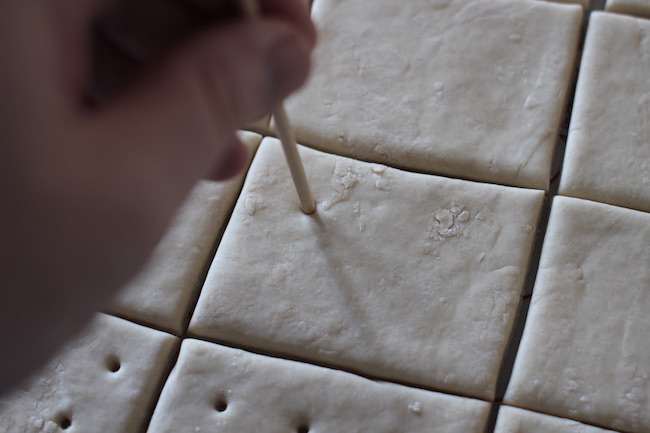 Poking holes in crackers.