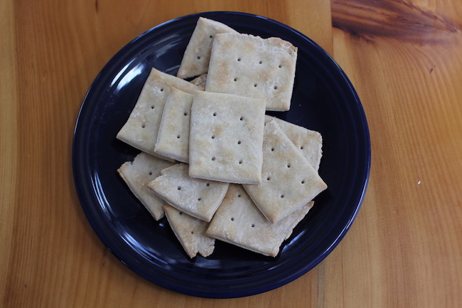 Half backed crackers in a plate.