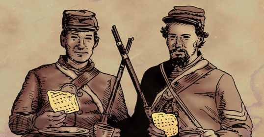 Two men in uniform are holding a piece of hardtack.