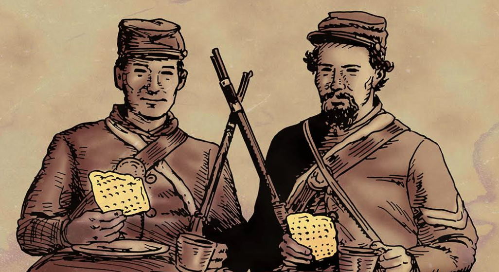 Two men in uniform are holding a piece of hardtack.