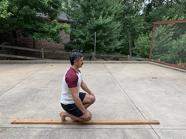 A man kneeling on one knee.