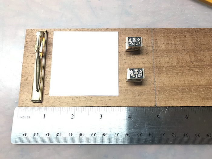 A ruler with note and Cufflink.