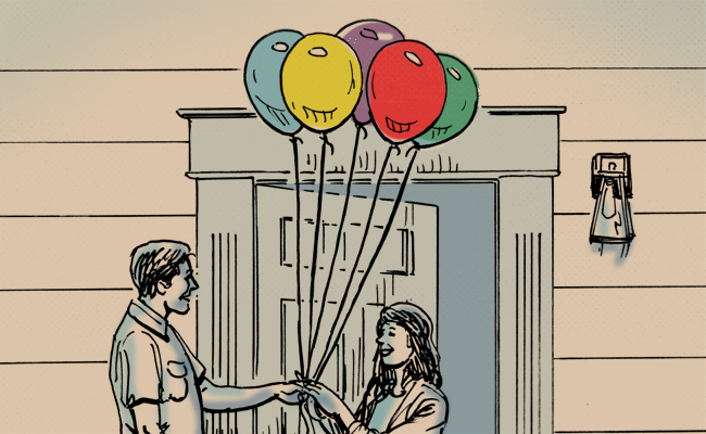 A man and woman stand holding balloons in front of a door, ready to celebrate a birthday.