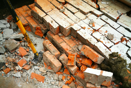 A pile of bricks with a shovel in the middle, breaking the Rules.
