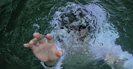 A hand immersed in liquid.