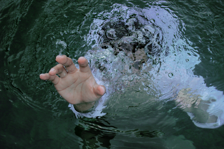 A hand immersed in liquid.