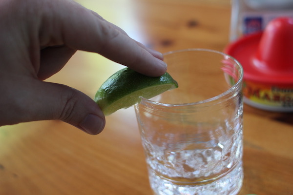 weting the rim of a glass with lemon.