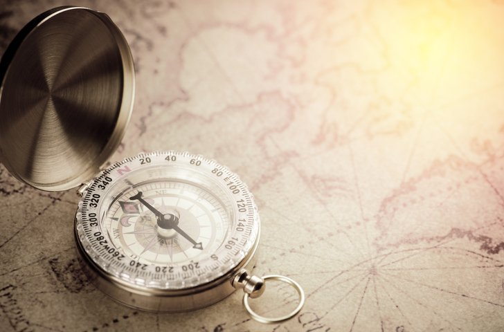 An old compass on a historic map for navigation enthusiasts.
