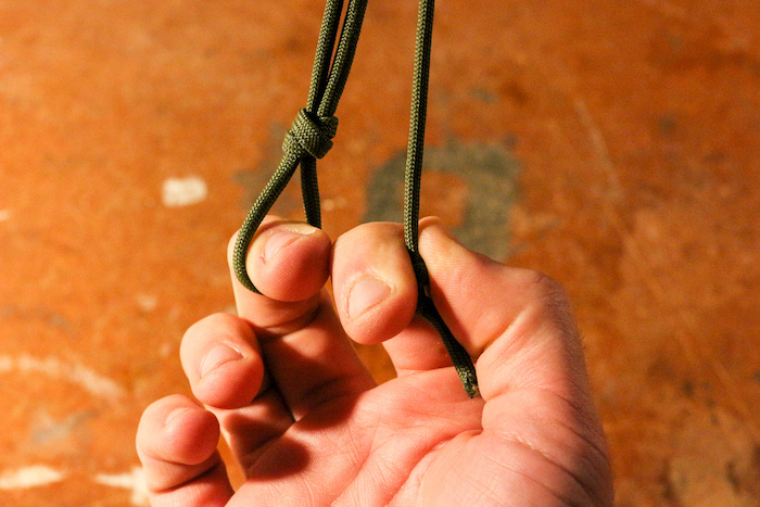 A man holding a paracord.