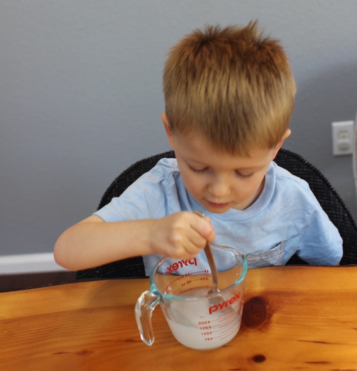 A kid is making invisible ink.