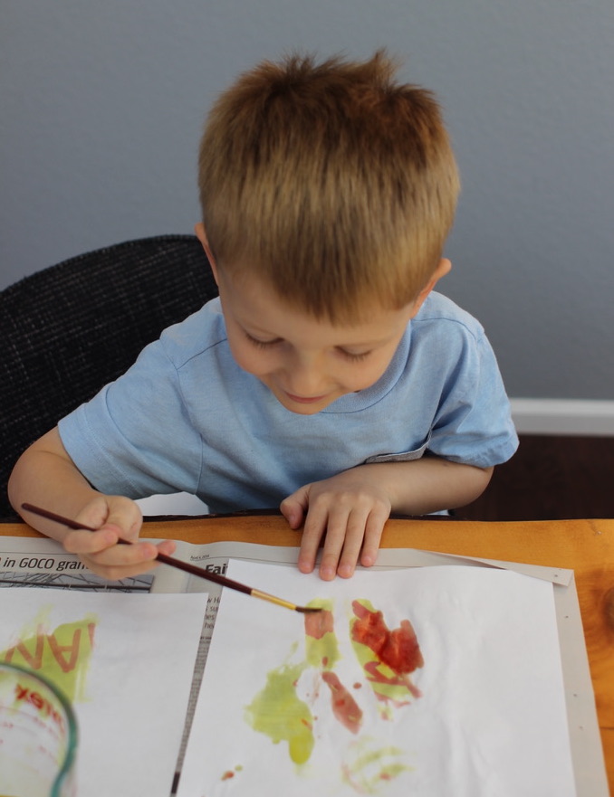 Kid is painting.