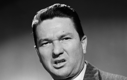 A black and white photo of a man in a suit.