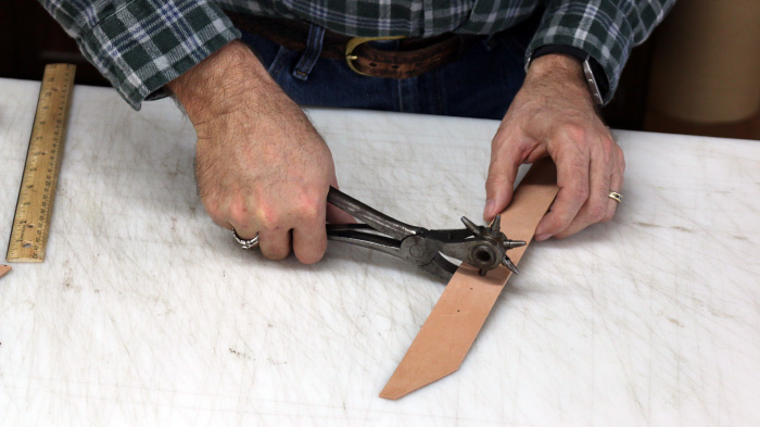 Rotatory punch used on leather tape.