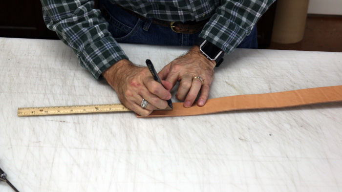 Marking points on leather strip.