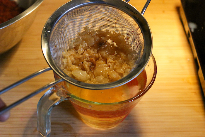 Straining the tallow in a jug.