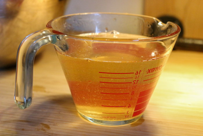 Transparent jug being filled with liquid.