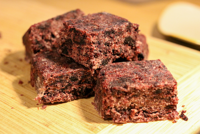 A stack of brownies on a cutting board prepared from a recipe.