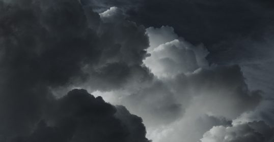 A grayscale image of a cloudy sky.